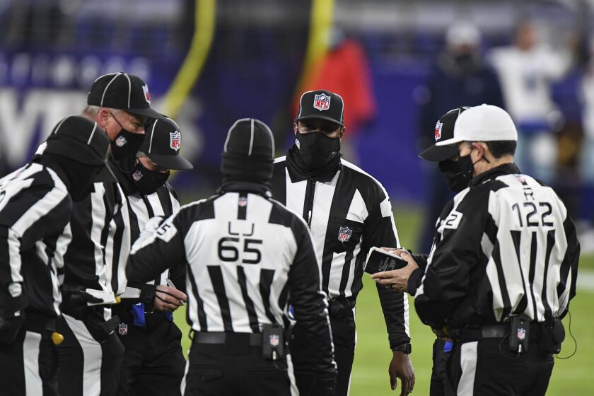 NFL officials huddle during the second half of an NFL football game between the Baltimore Ravens and the Dallas Cowboys, Tuesday, Dec. 8, 2020, in Baltimore. (AP Photo/Terrance Williams)