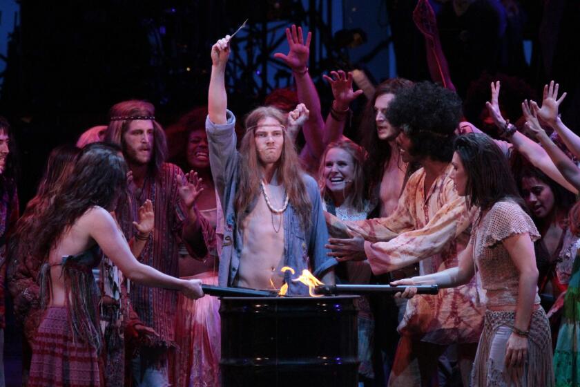 Hunter Parrish (center, arm up) as Claude and the ensemble in the performance of "Hair" at the Hollywood Bowl on Aug. 1, 2014.