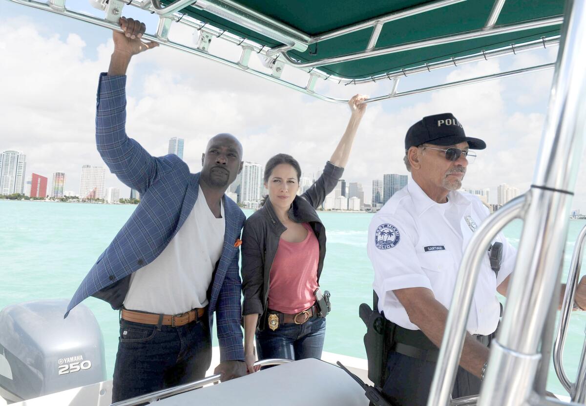 Morris Chestnut, left, and Jaina Lee Ortiz appear in a scene from "Rosewood."