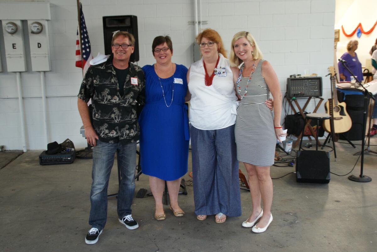 Greg Ridge, Caroline McNabb, Amber Davidson and Liz McNabb, left to right, the four newly elected leaders of the Costa Mesa Democratic Club, pose for a photo during the club's kickoff party Tuesday night.