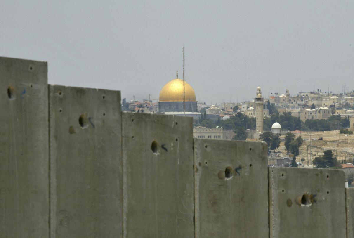 Jerusalem's Dome of the Rock, seen over a border wall from East Jerusalem. 