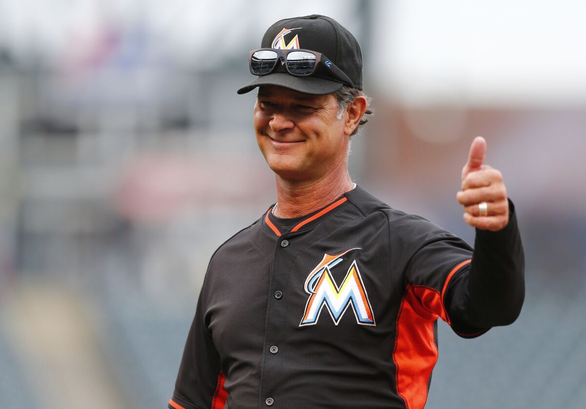 Marlins Manager Don Mattingly gives a thumbs-up to fans during batting practice before a game against the Colorado Rockies on Aug 5.