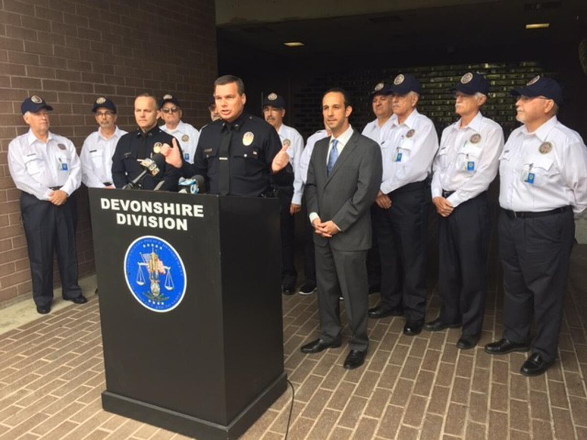 LAPD Cmdr. Kris Pitcher, flanked by Capt. Brian Pratt and Councilman Mitch Englander, introduces members of the LAPD's first "volunteer citizen patrol" at the department's Devonshire station.