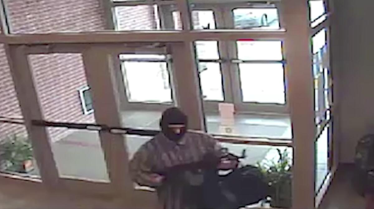 An image from surveillance video shows the suspect known as the "AK-47 Bandit." Richard Gathercole, a Montana man federal officials suspect is the serial bank robber, is in custody in Nebraska.