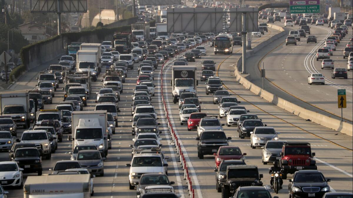 Motorists slog through traffic on the 110 Freeway. The state is racing to spend new gas tax and vehicle fee revenues on improvements to California's roads and bridges as a GOP drive to repeal the levies gains momentum.