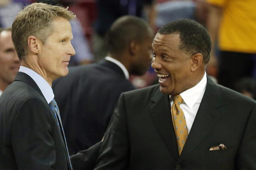 Golden State Warriors Coach Steve Kerr, left, is congratulated by assistant coach Alvin Gentry after a win over the Sacramento Kings on Oct. 29.