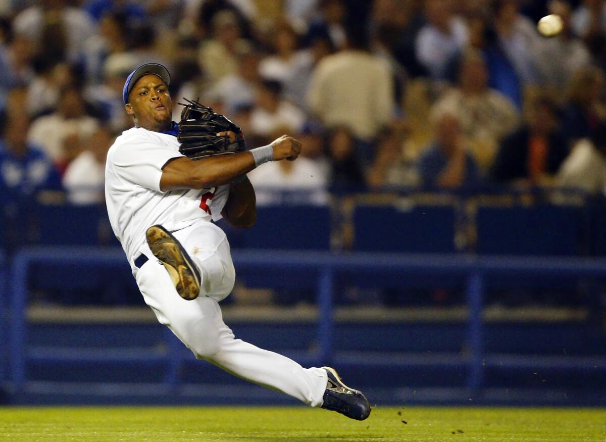 Adrián Beltré throws a player out for the Dodgers.