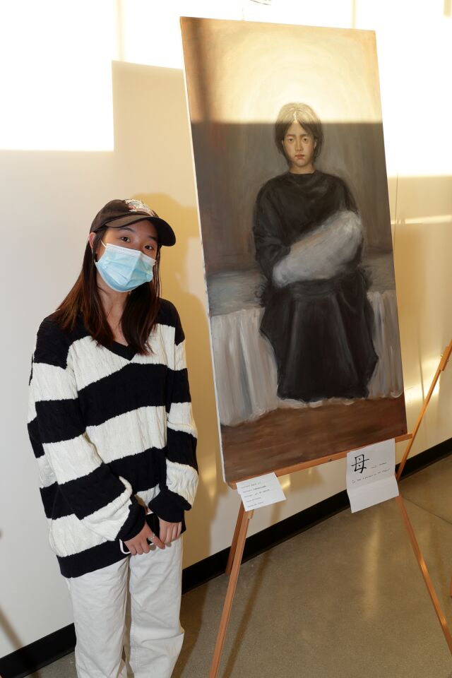 Julia Liu with her painting "Motherhood"