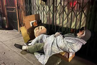 LOS ANGELES, CA - APRIL 27, 2024 - An elderly homeless sleeps on a bed of boxes on a sidewalk at nighttime in Chinatown in Los Angeles on April 22, 2024. (Genaro Molina/Los Angeles Times)
