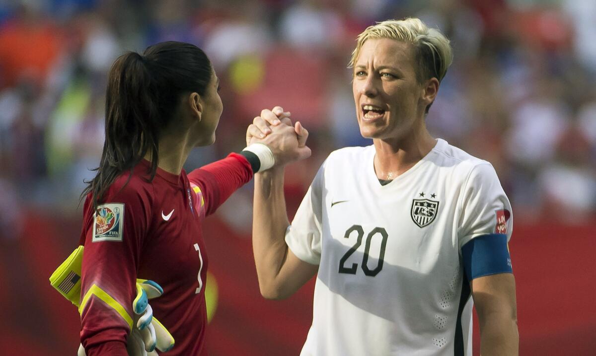 Abby Wambach (10) and Hope Solo celebrate after the United States' 1-0 win over Nigeria on June 16 at the Women's World Cup.