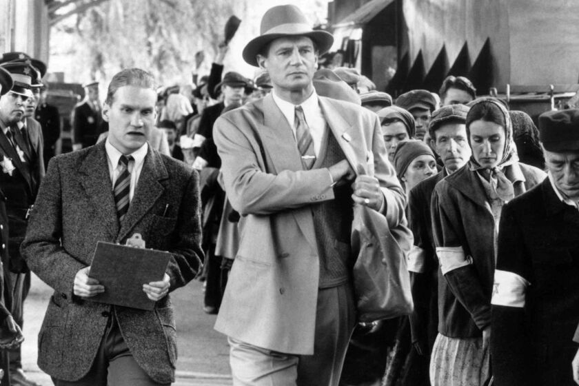 898411 (BC-BPI-LISTS) German industrialist Okar Schindler (LIAM NEESON, center) searches for his plant manager Itzhak Stern among a trainload of Polish Jews about to be deported to Auschwitz-Birkenau in SCHINDLER S LIST. BPI DIGITAL PHOTO 1993 UNIVERSAL CITY STUDIOS, INC. CR: DAVID JAMES