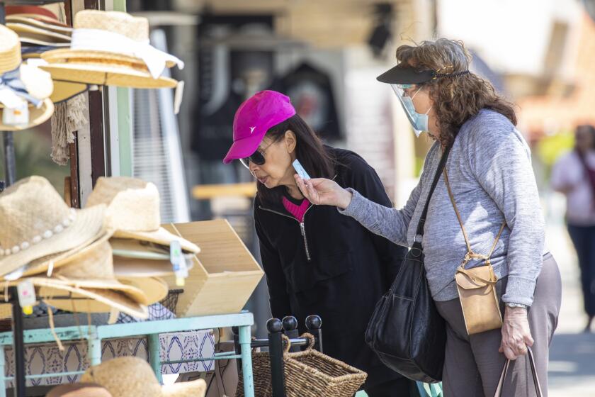 Redondo Beach, CA - May 14: People walked and shopped along S. Catalina Avenue in the Riviera Village shopping area of Redondo Beach, CA, a day after the Centers for Disease Control and Prevention (CDC) loosened guidelines for vaccinated people, with masks no longer being necessary when outdoors or in most indoor situations, Friday, May 14, 2021. The new guidelines state that fully vaccinated people no longer need to wear a mask or physically distance in any setting, except where required by federal, state, local, tribal, or territorial laws, rules, and regulations, including local business and workplace guidance. (Jay L. Clendenin / Los Angeles Times)