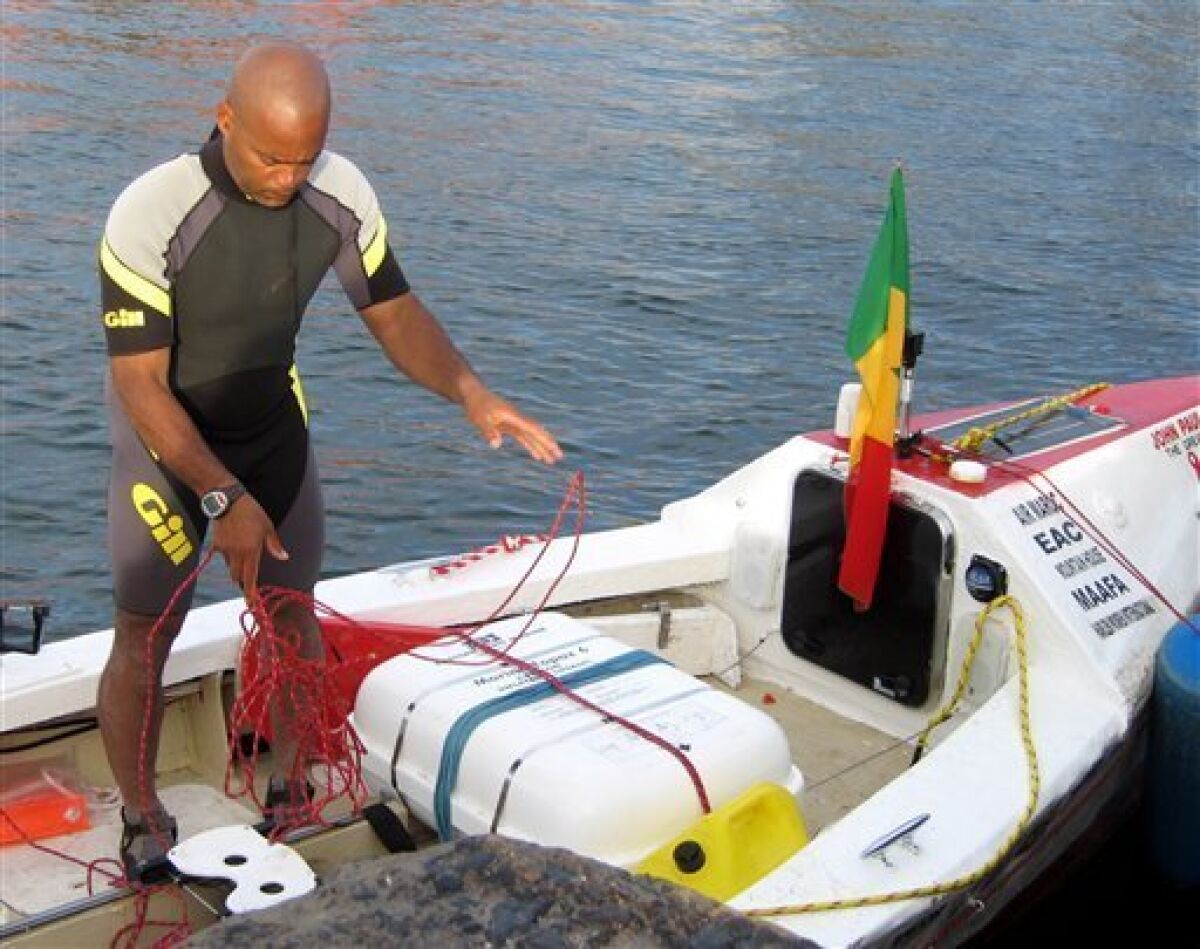 FILE - In this May 7, 2006 file photo, Victor Mooney prepares his rowboat for a transatlantic voyage between Goree Island, Senegal, and New York. Mooney began his third attempt to row across the Atlantic Ocean on Saturday, Feb. 26, 2011, hoping to make landfall at New York in six to eight months. (AP Photo/Hilary Heuler, File)