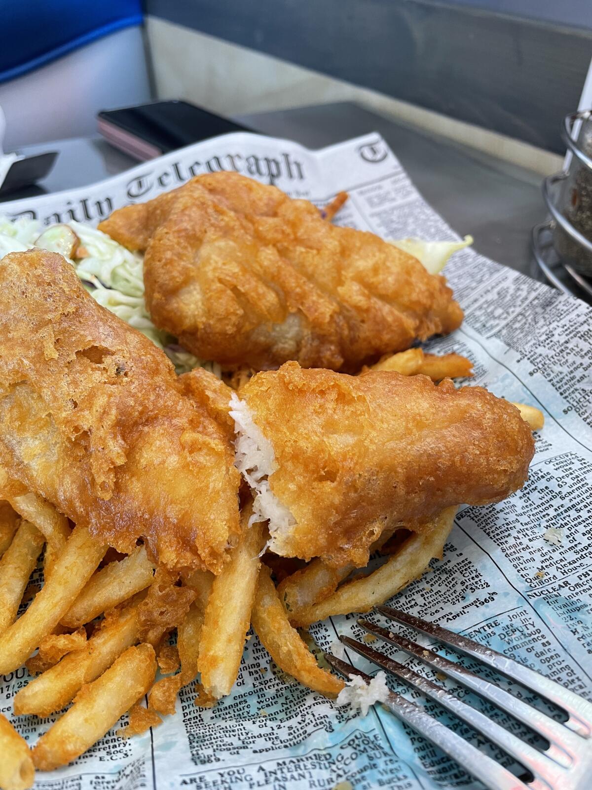 Simply Fish’s fish and chips meal includes three generous pieces of fish, fresh fries, and a serving of cooling coleslaw.