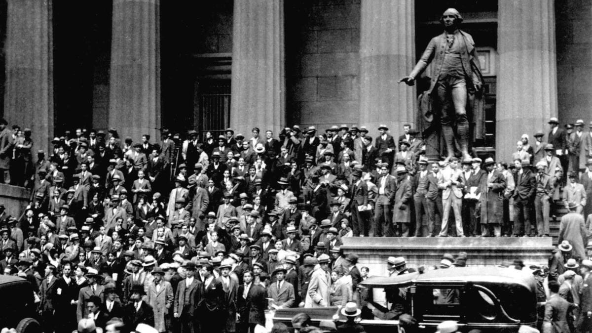People gather across the street from the New York Stock Exchange in New York on Oct. 24, 1929. On Oct. 28, the Dow dropped 13% on what would be called Black Monday. It fell another 13% the next day, Black Tuesday. (Associated Press)