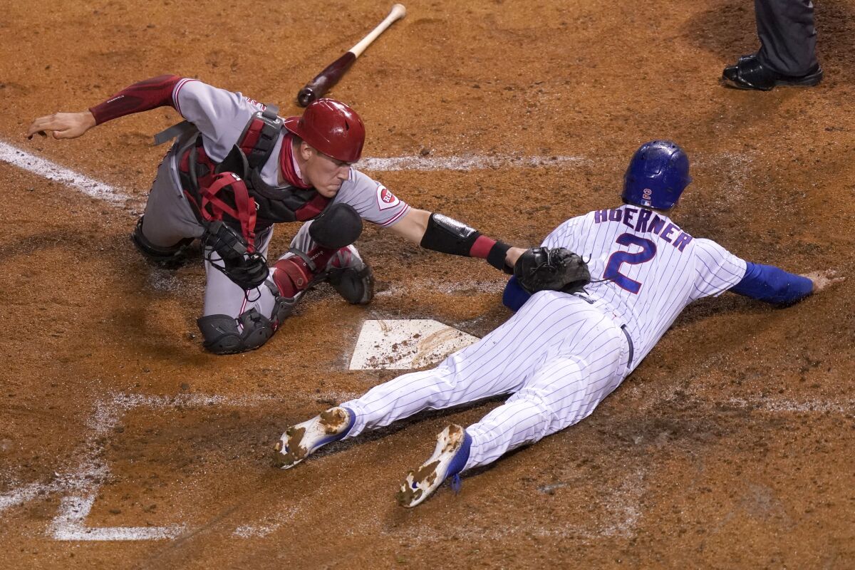 Chicago Cubs' Nico Hoerner (2) is safe at home past the tag of Cincinnati Reds catcher Tyler Stephenson during the fourth inning of a baseball game Thursday, Sept. 10, 2020, in Chicago. (AP Photo/Charles Rex Arbogast)