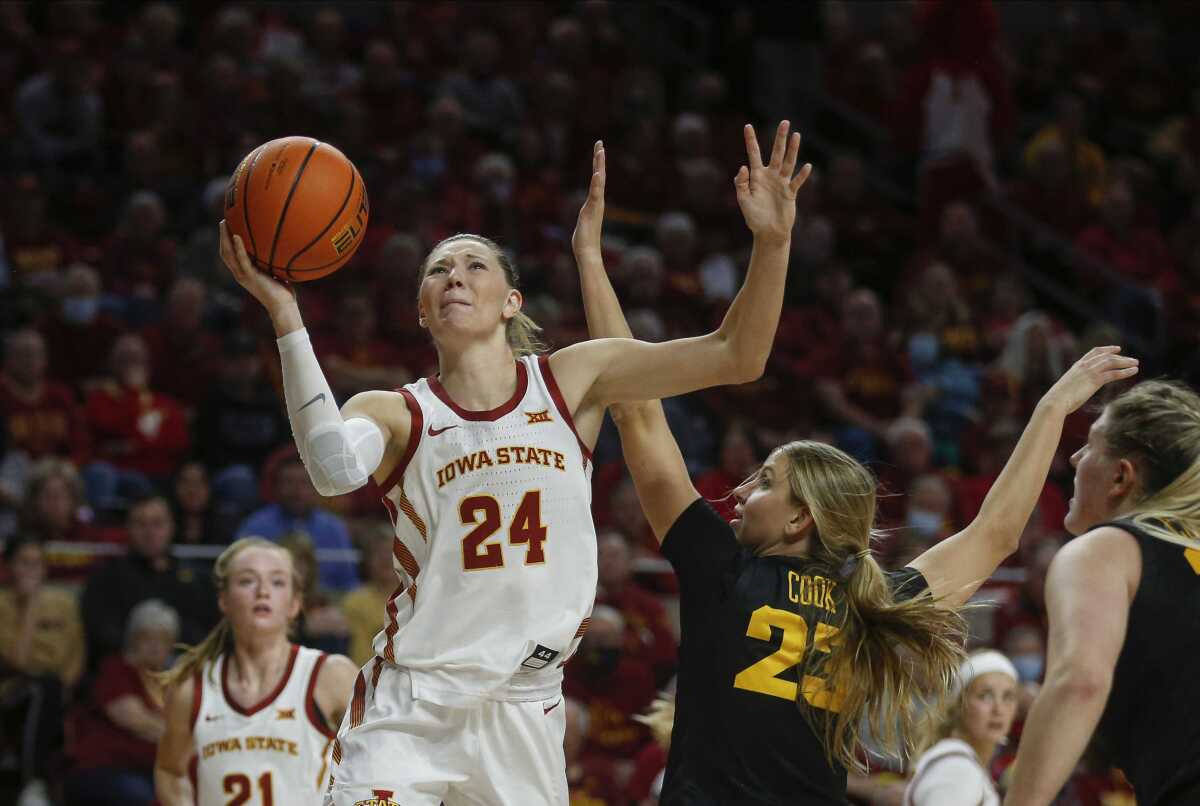 Iowa State guard Ashley Joens drives past Iowa forward Logan Cook during an NCAA college basketball game Wednesday, Dec. 8, 2021, in Ames, Iowa. (Bryon Houlgrave/The Des Moines Register via AP)