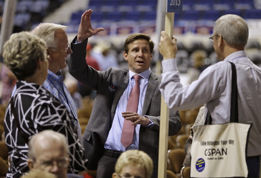 FILE - In this May 17, 2013, file photo, candidate for Governor of Virginia, Pete Snyder, center, gestures as he talks to delegates during the opening of the Virginia Republican convention in Richmond, Va. The GOP gubernatorial candidate will be chosen during the party's May 8 nominating convention. (AP Photo/Steve Helber, File)