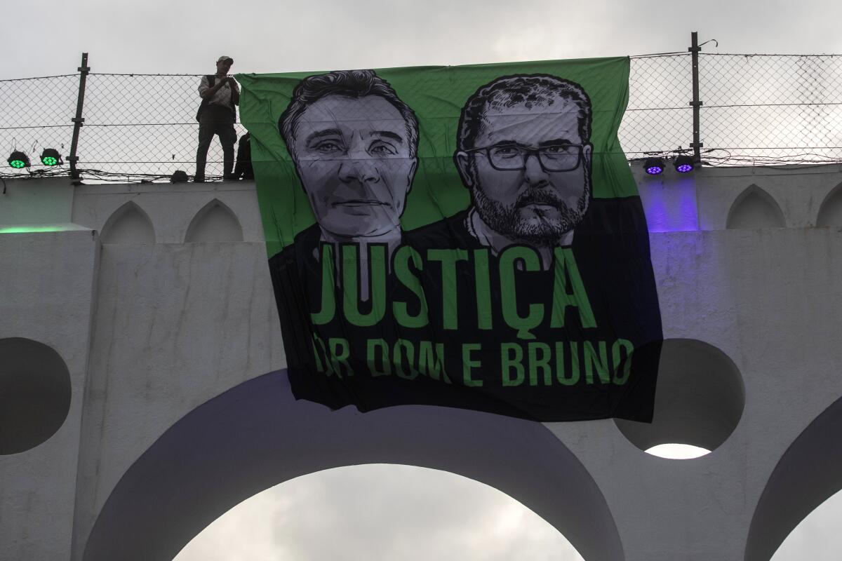 Banner hung from bridge demanding justice for two slain men