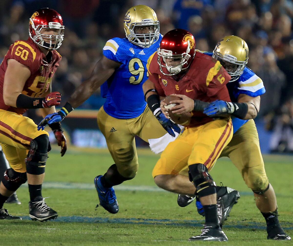 USC quarterback Cody Kessler is brought down by UCLA defensive lineman Eddie Vanderdoes during the fourth quarter. Kessler was sacked six times by the Bruins in the Trojans' 38-20 loss.