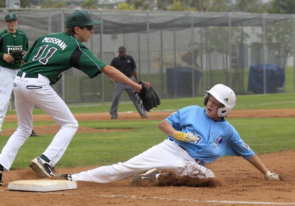 Earthpack's Luc Stuka slides to beat the throw to Dick's Sporting Goods' Drake Mossman at third base.