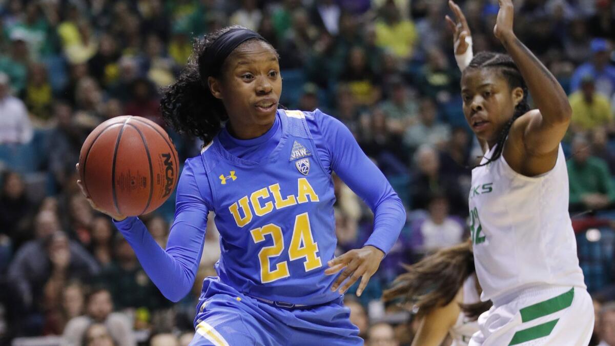 UCLA's Japreece Dean is defended by Oregon's Oti Gildon during the first half of the Pac-12 women's semifinals on March 9.