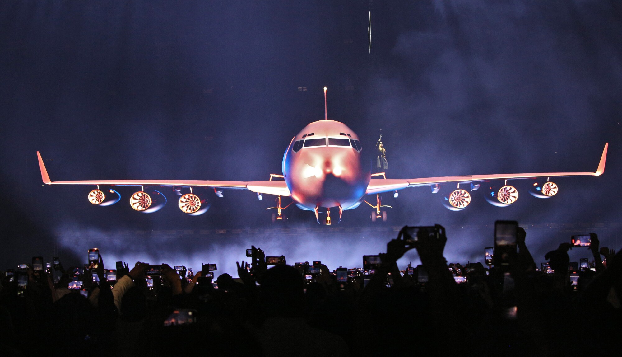 Daddy Yankee is seen seemingly exiting a virtual plane on the stage-wide 