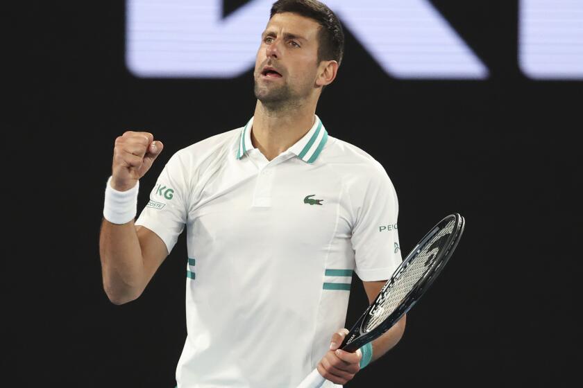 Serbia's Novak Djokovic celebrates after defeating Canada's Milos Raonic during their fourth round match at the Australian Open tennis championship in Melbourne, Australia, Monday, Feb. 15, 2021.(AP Photo/Hamish Blair)