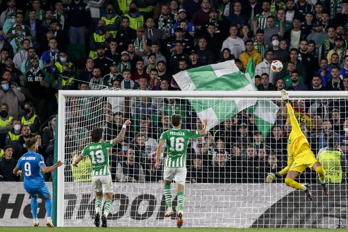 Zenit's Yuri Alberto, left, tries a shot during the Europa League play off, second leg soccer match between Betis and Zenit at the Benito Villamarin stadium in Seville, Spain, Thursday, Feb. 24, 2022. (AP Photo/Miguel Morenatti)