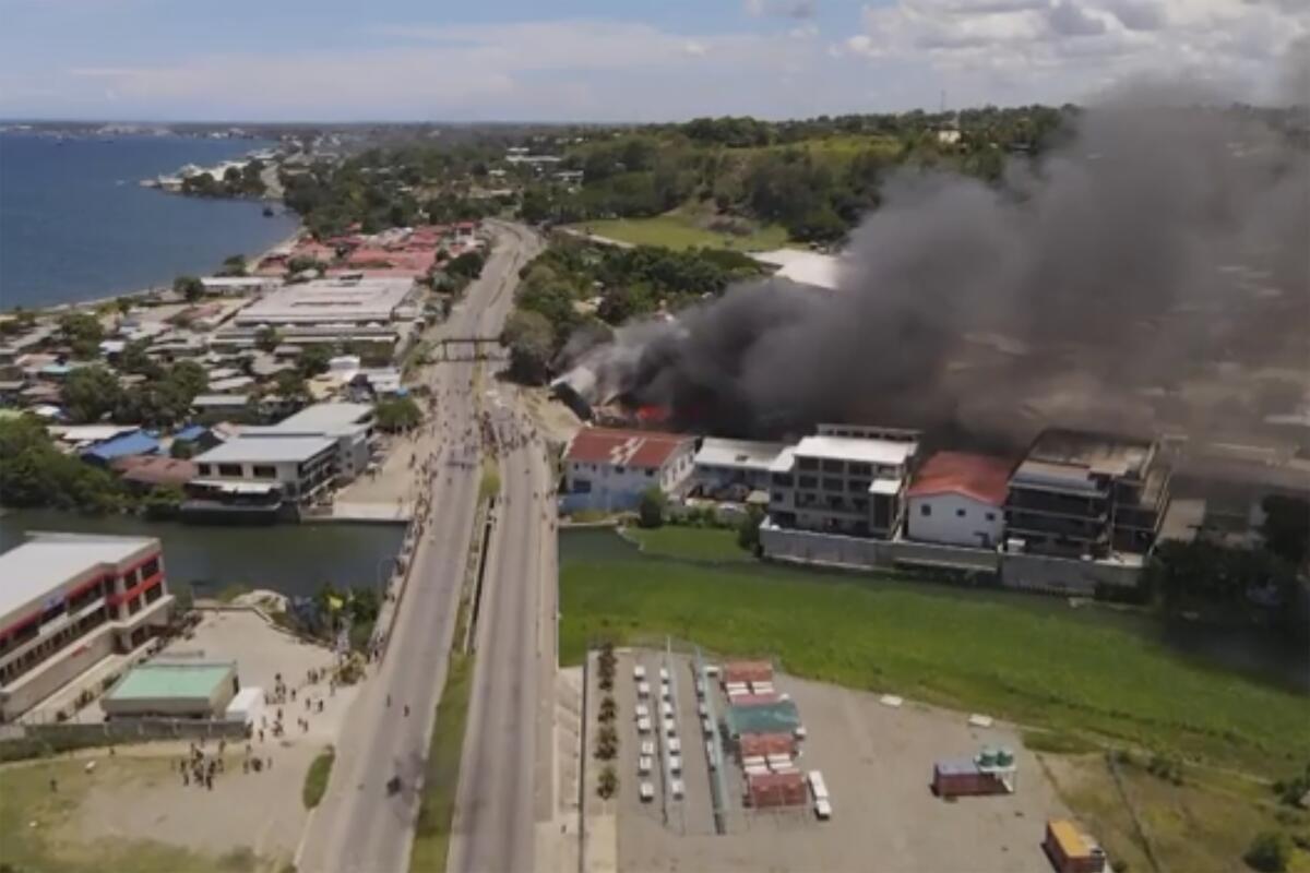 Smoke rises from burning buildings in Honiara, Solomon Islands