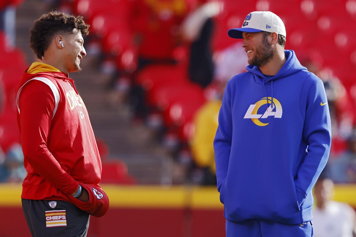 The Chiefs' Patrick Mahomes, left, talks with the Rams' Matthew Stafford before a game in 2022.