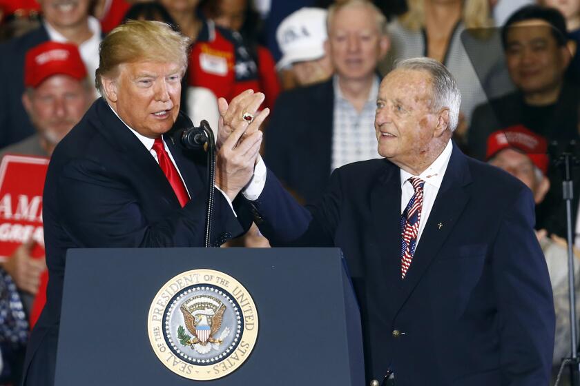 President Donald Trump points to the National Championship ring that Bobby Bowden is wearing after he speaks at a rally, Saturday, Nov. 3, 2018, in Pensacola, Fla. (AP Photo/Butch Dill)