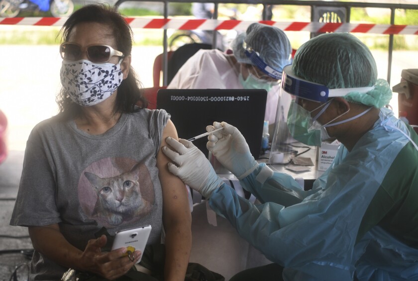 A health worker administers a dose of the AstraZeneca COVID-19 vaccine to a resident of the Klong Toey area, a neighborhood currently having a spike in coronavirus cases, in Bangkok, Thailand, Monday, May 10, 2021. The health authorities in Thailand said Monday they have confirmed the country’s first cases of the Indian variant of the coronavirus, in a Thai woman and her 4-year-old son who have been in state quarantine since arriving from Pakistan. (AP Photo/Vichan Poti)