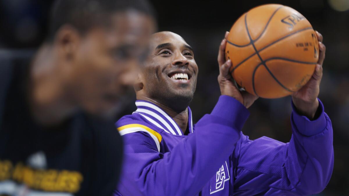 Lakers star Kobe Bryant smiles while warming up before the team's 111-103 win over the Denver Nuggets on Dec. 30.