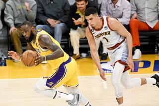 LOS ANGELES, CA - MAY 22: Los Angeles Lakers forward LeBron James, left, handles the ball on a fast break.