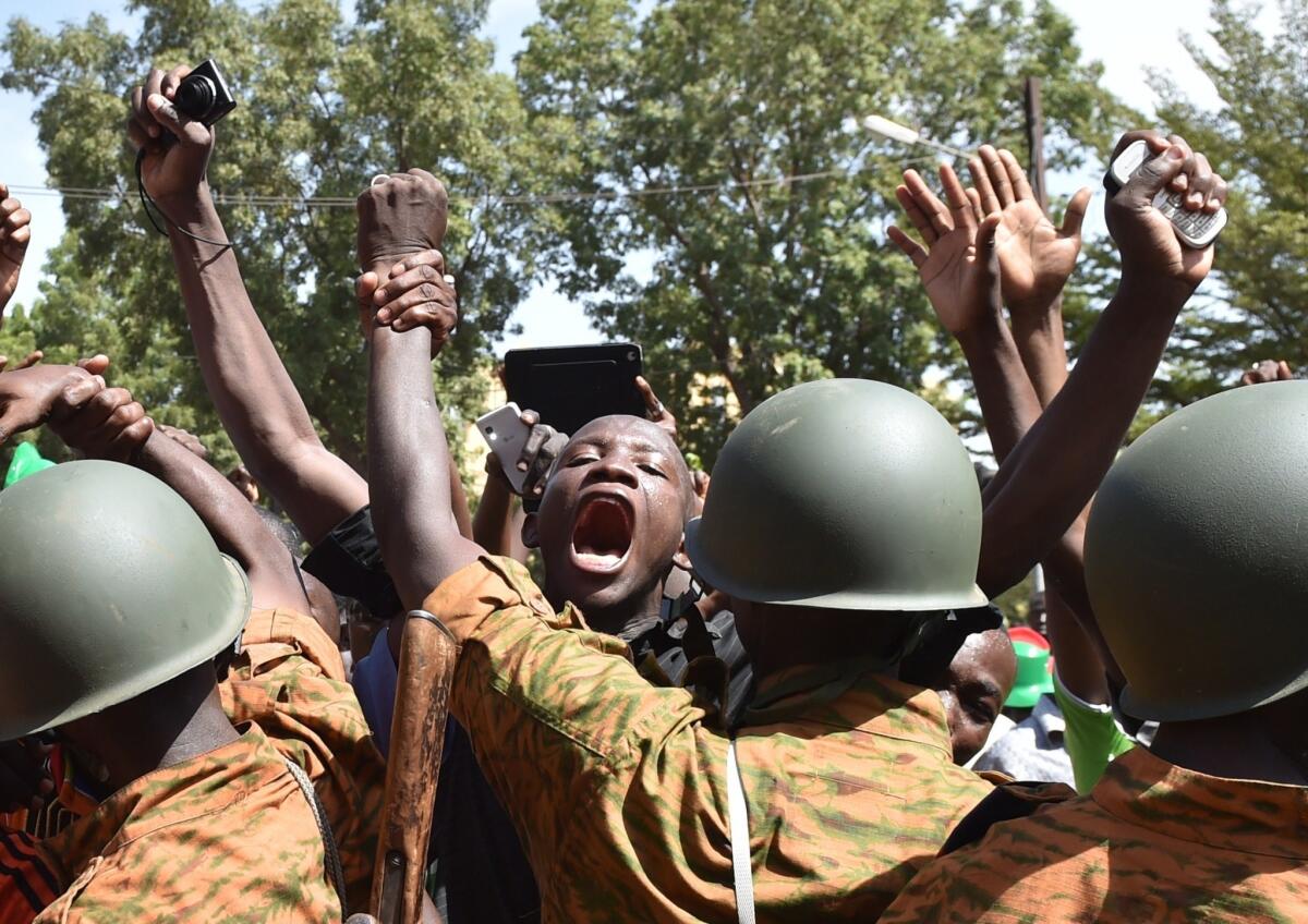 A crowd gathers in front of army headquarters in Burkina Faso's capital, Ouagadougou, demanding that the army take over after the resignation of President Blaise Compaore on Oct. 31.