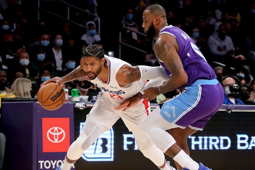 LOS ANGELES, CALIF. - DEC. 3, 2021. Clippers forward Paul George drives to the basket.