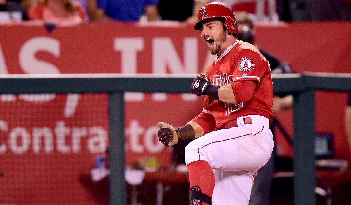 Angels' Johnny Giavotella celebrates his triple to score David Freese and take a 6-3 lead over the Seattle Mariners during the sixth inning on Friday.