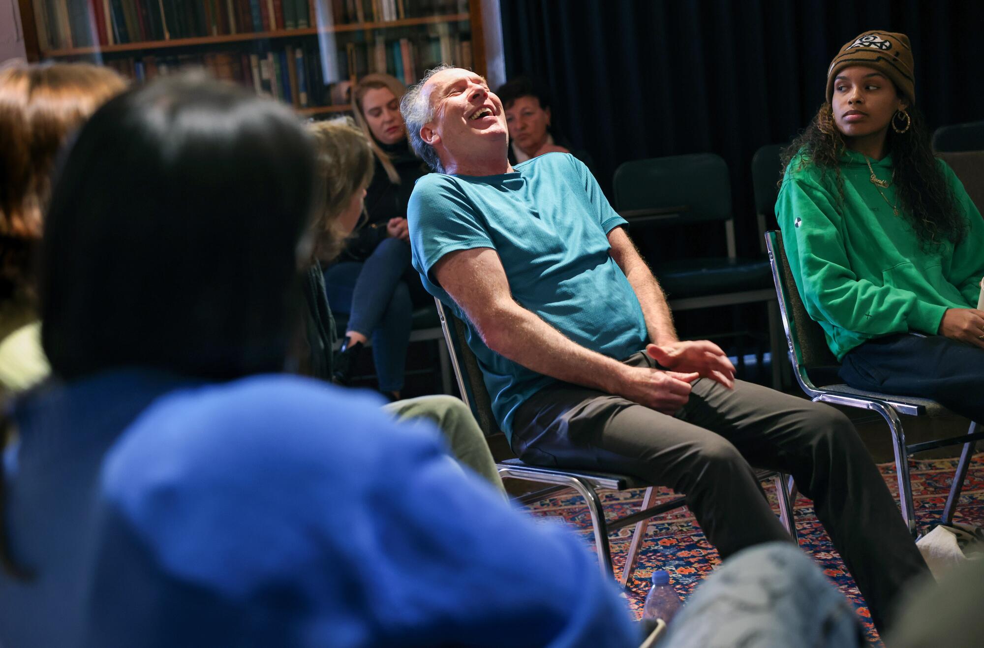 Michael Allison, 62, laughs a little while sharing with the group of participants in the death cafe.