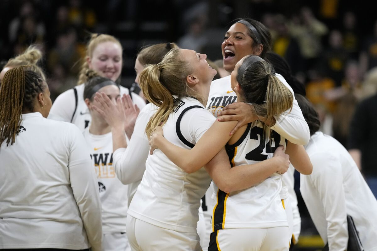 Iowa players celebrate after a second-round college basketball game against Georgia in the NCAA Tournament, Sunday, March 19, 2023, in Iowa City, Iowa. Iowa won 74-66. (AP Photo/Charlie Neibergall)