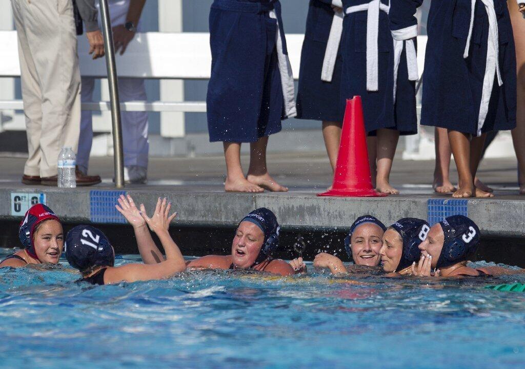 The Newport Harbor High girls' water polo team celebrates a 4-3 win over Foothill in a semifinal match of the Holiday Cup on Saturday.
