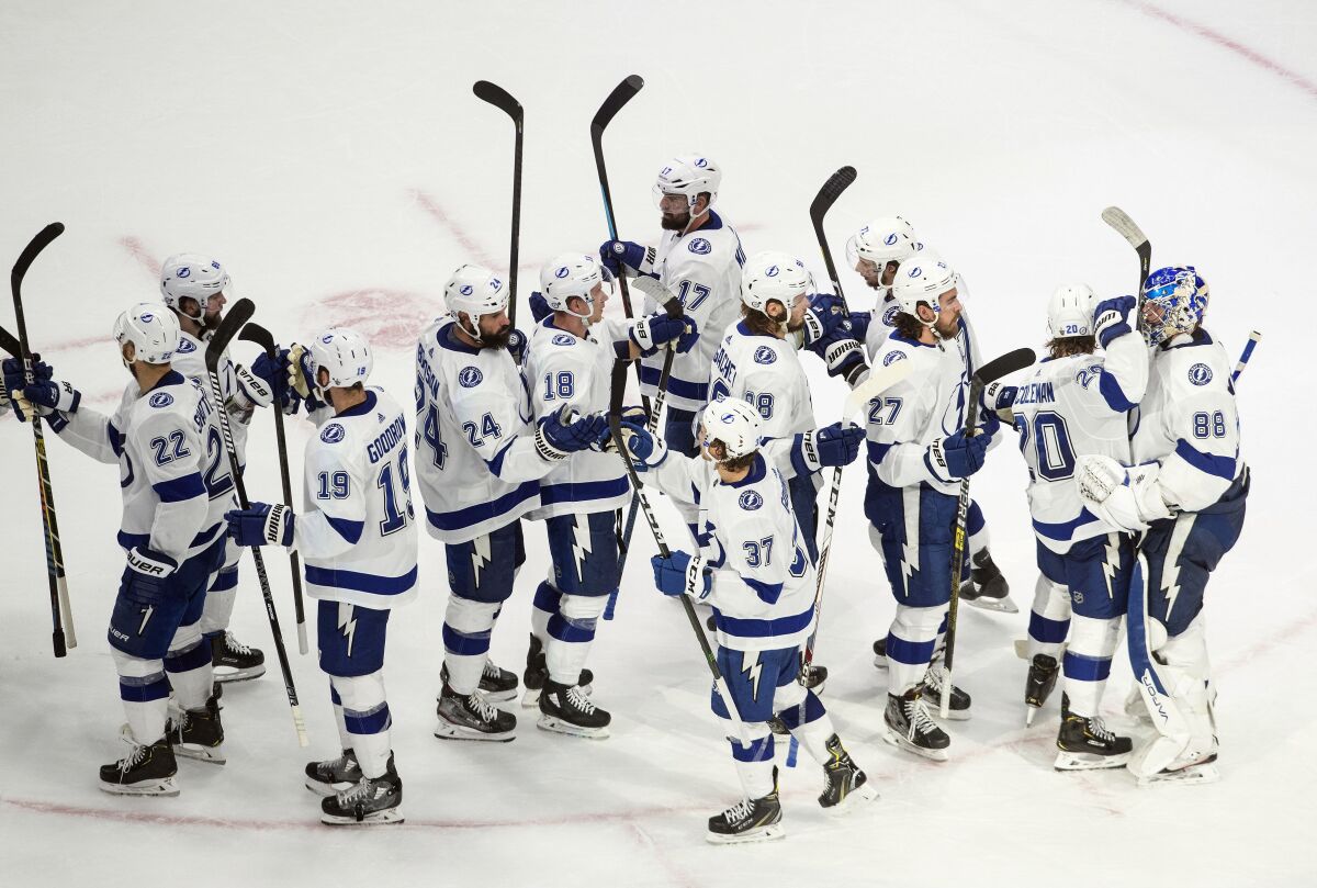 Tampa Bay Lightning players celebrate their victory over the New York Islanders following NHL Eastern Conference final playoff game action in Edmonton, Alberta, Sunday, Sept. 13, 2020. (Jason Franson/The Canadian Press via AP)