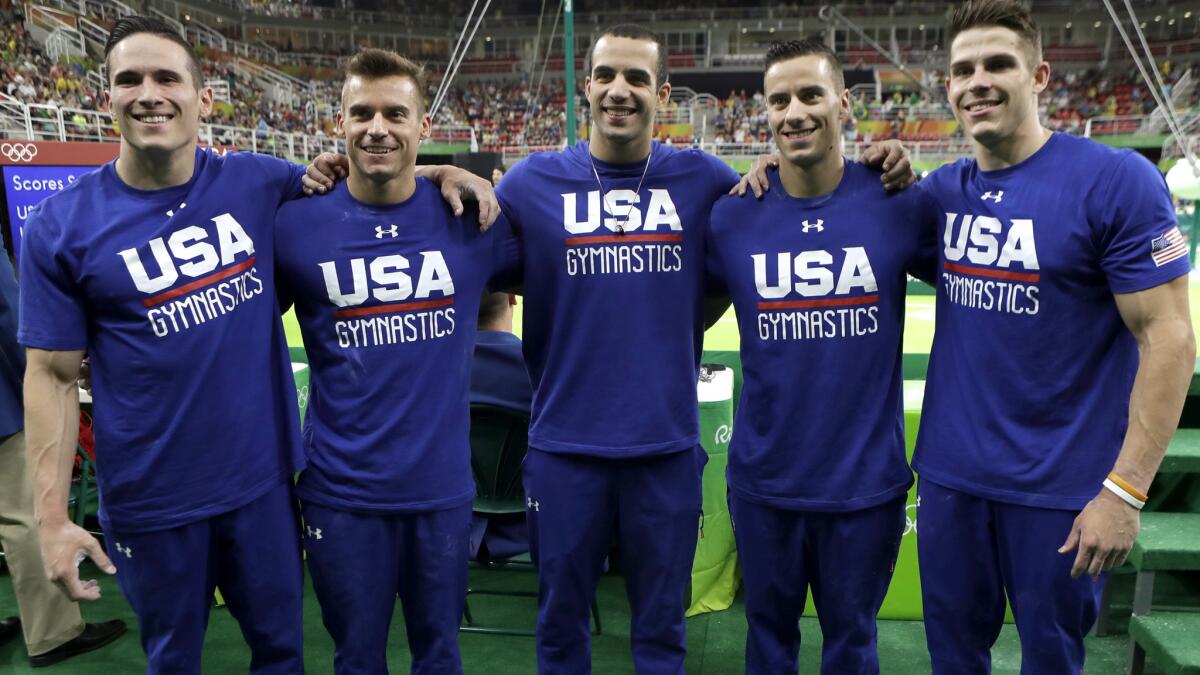 U.S. gymnasts Chris Brooks, Jake Dalton, Danell Leyva, Sam Mikulak and Alex Naddour, from left, finished second behind China in qualifying and advanced to the team finals.
