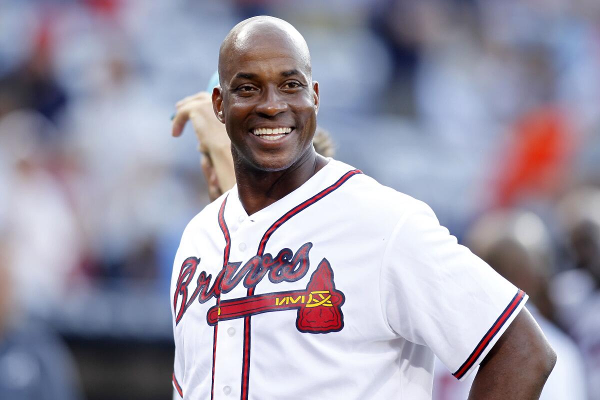 Former Atlanta Braves first baseman Fred McGriff smiles on the field before a game against the Miami Marlins.