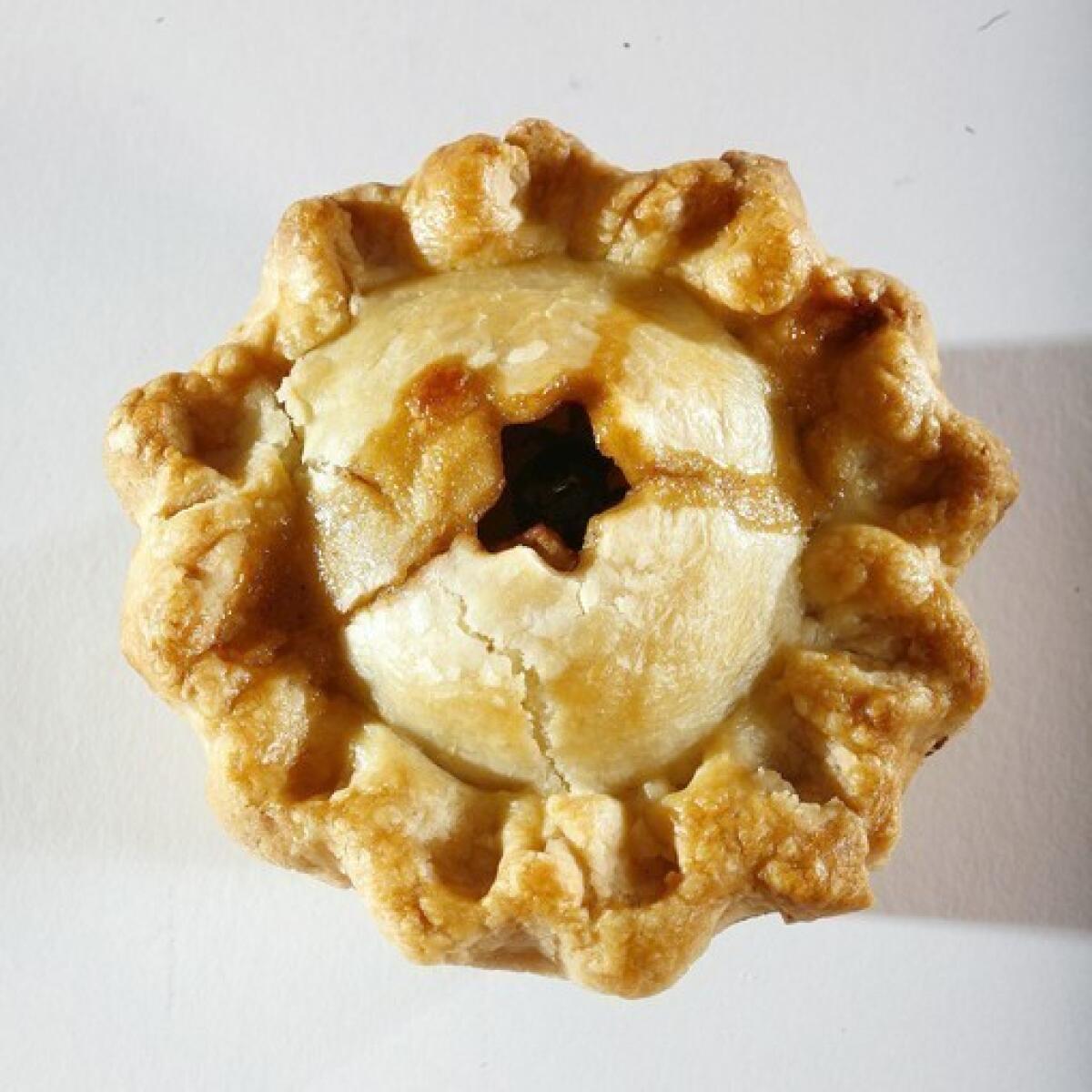 The apple mini-pie has a double crust and is loaded with rum-plumped raisins.
