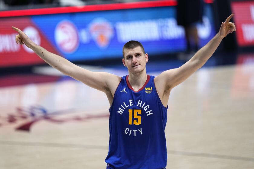 Denver Nuggets center Nikola Jokic (15) celebrate the team's double-overtime win against the Portland Trail Blazers in Game 5 of a first-round NBA basketball playoff series Tuesday, June 1, 2021, in Denver. (AP Photo/Jack Dempsey)