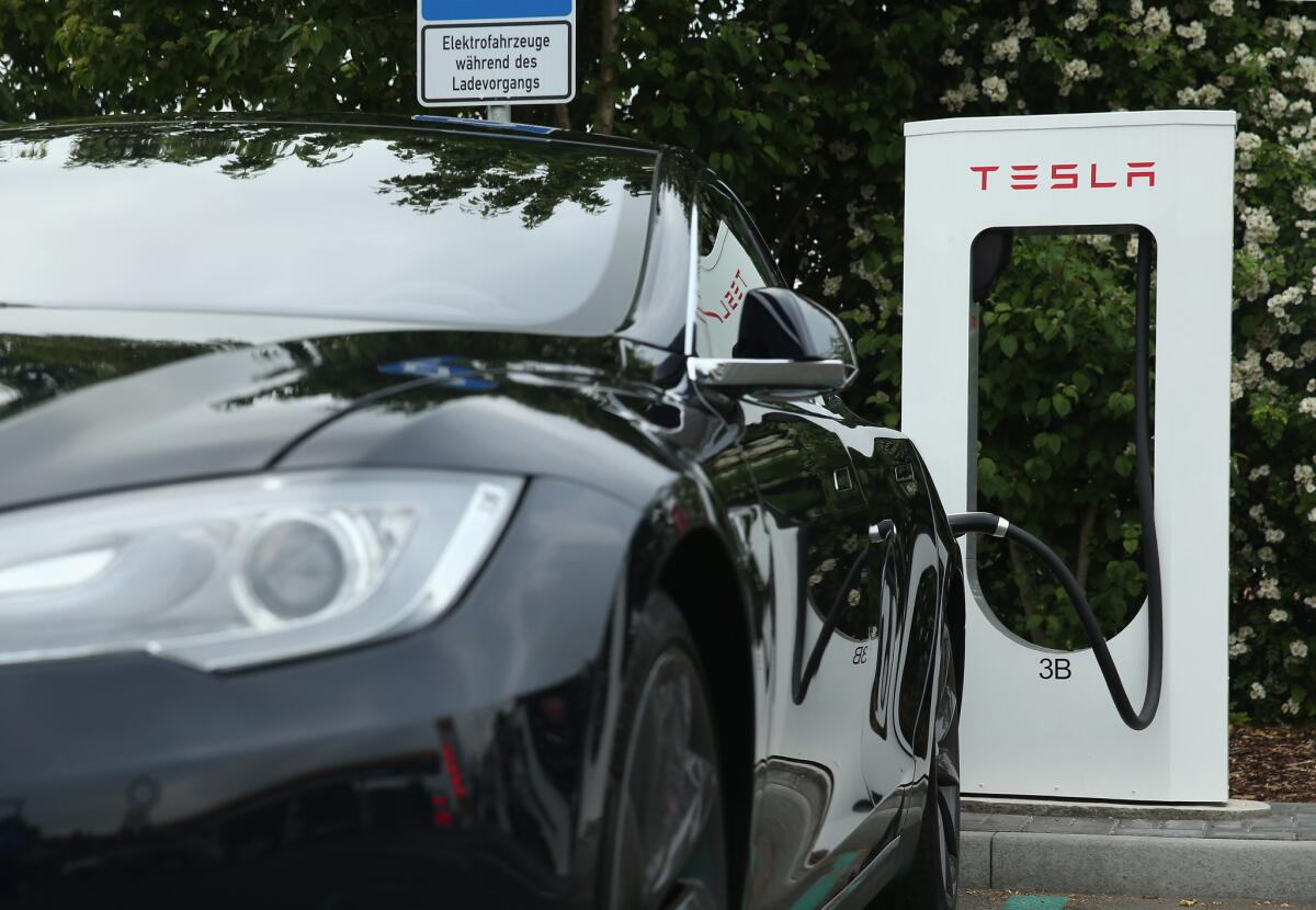 A Model S sedan is parked at a Tesla charging station at a highway rest stop near Rieden, Germany.