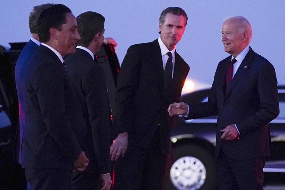 Gov. Gavin Newsom and others with President Biden at an airport