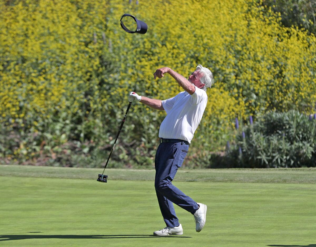 George Schmidt of Newport Beach throws his visor in the air after sinking a birdie putt during the Jones Cup on Thursday.