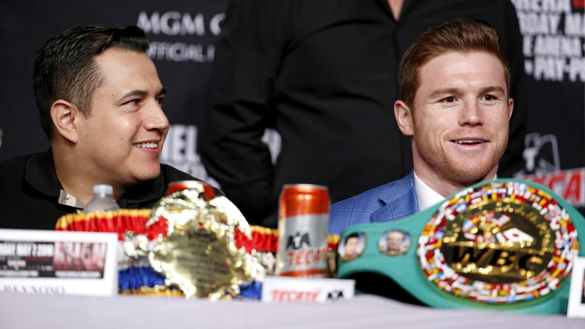 Trainer Eddy Reynoso, left, and boxer Canelo Alvarez take part in a news conference in Las Vegas on Wednesday.